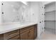 Well-lit bathroom with a double vanity featuring modern fixtures, a large mirror, and access to a shower and closet at 18883 E Celtic Manor Dr, Queen Creek, AZ 85142