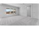 A bright and spacious bedroom featuring plush carpeting, ample natural light, and neutral paint at 18883 E Celtic Manor Dr, Queen Creek, AZ 85142