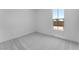 Neutral bedroom with carpet and a large window at 18883 E Celtic Manor Dr, Queen Creek, AZ 85142