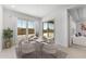 Dining area with modern table set, large windows, and sliding glass door access to backyard at 18883 E Celtic Manor Dr, Queen Creek, AZ 85142