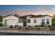 Inviting single-story stucco home featuring a tile roof, desert landscaping, and an attached two car garage at 18883 E Celtic Manor Dr, Queen Creek, AZ 85142