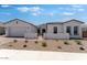 Charming single-story home featuring a stucco exterior, desert landscaping, and a two-car garage at 18883 E Celtic Manor Dr, Queen Creek, AZ 85142