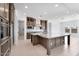 A modern kitchen features a large island, stainless steel appliances, and plenty of counter space at 18883 E Celtic Manor Dr, Queen Creek, AZ 85142