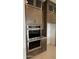Modern kitchen design showcasing stainless steel double ovens, granite countertops, and custom cabinets at 18883 E Celtic Manor Dr, Queen Creek, AZ 85142