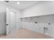Laundry room with shelving, tile floors and white walls at 18883 E Celtic Manor Dr, Queen Creek, AZ 85142