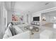 Bright living room featuring a comfortable white sofa, colorful art, and ample natural light at 18883 E Celtic Manor Dr, Queen Creek, AZ 85142