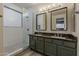Bathroom features a dual-sink vanity, granite countertop, and glass shower at 19323 E Canary Way, Queen Creek, AZ 85142