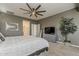 Bedroom features a contemporary ceiling fan, modern art, and gray color palette at 19323 E Canary Way, Queen Creek, AZ 85142