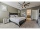 Spacious bedroom features a ceiling fan, soft carpet, and ensuite bathroom at 19323 E Canary Way, Queen Creek, AZ 85142