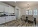 Bright dining area with modern lighting, wood-look flooring, and view into the kitchen at 19323 E Canary Way, Queen Creek, AZ 85142