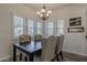 Elegant dining room featuring a dark wood table and upholstered chairs with nailhead trim at 19323 E Canary Way, Queen Creek, AZ 85142
