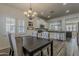 Open-concept dining area with views of the kitchen, chandelier and plantation shutters at 19323 E Canary Way, Queen Creek, AZ 85142