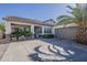 Attractive single-story home with a desert landscape, palm tree, and a spacious two-car garage at 19323 E Canary Way, Queen Creek, AZ 85142