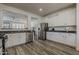 Kitchen with stainless steel appliances, granite counters, open to the living room at 19323 E Canary Way, Queen Creek, AZ 85142