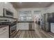 Modern kitchen featuring stainless steel appliances, granite countertops, and an open layout at 19323 E Canary Way, Queen Creek, AZ 85142