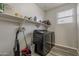 Laundry Room featuring modern black appliances, neutral colors, and bright lighting at 19323 E Canary Way, Queen Creek, AZ 85142