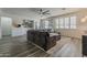 Stylish living room with wood-look floors, gray sectional sofa, and modern decor at 19323 E Canary Way, Queen Creek, AZ 85142