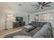 Well-lit living room featuring a large sectional sofa and modern entertainment center at 19323 E Canary Way, Queen Creek, AZ 85142