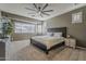 Serene main bedroom with carpet, ceiling fan, and a large window at 19323 E Canary Way, Queen Creek, AZ 85142