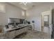 Office boasts large monitors, neutral walls, and bright shutters at 19323 E Canary Way, Queen Creek, AZ 85142