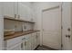 Butlers pantry features white cabinets, wood countertop, and modern appliances at 19323 E Canary Way, Queen Creek, AZ 85142