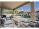 Covered patio with comfortable seating overlooking the pool and landscaped backyard at 19323 E Canary Way, Queen Creek, AZ 85142