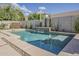 Cool blue backyard pool featuring desert landscaping, lounge chairs, and waterfall feature at 19323 E Canary Way, Queen Creek, AZ 85142