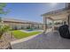 Sparkling pool with water feature, artificial grass, and covered patio for outdoor enjoyment at 19323 E Canary Way, Queen Creek, AZ 85142