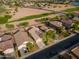 Aerial view showcases a neighborhood, green spaces, and streets at 21533 N Greenway Rd, Maricopa, AZ 85138