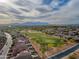 An aerial shot showcases neighborhood, golf course, and mountain views at 21533 N Greenway Rd, Maricopa, AZ 85138