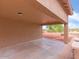 Covered back patio with stone floor and view of gravel backyard at 21533 N Greenway Rd, Maricopa, AZ 85138
