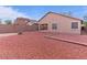 Spacious backyard features low-maintenance rock landscaping and a covered patio at 21533 N Greenway Rd, Maricopa, AZ 85138