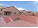 Gravel backyard with covered patio, low wall and block fence at 21533 N Greenway Rd, Maricopa, AZ 85138