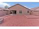 The backyard features a gravel-covered space, block wall, and covered patio at 21533 N Greenway Rd, Maricopa, AZ 85138