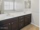 Bathroom featuring dual sinks, dark cabinets, and tile floors at 21533 N Greenway Rd, Maricopa, AZ 85138