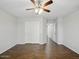 Bedroom with ceiling fan, tile floor, and hall access at 21533 N Greenway Rd, Maricopa, AZ 85138