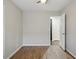 Bedroom with an open closet, wood-look flooring, and neutral paint at 21533 N Greenway Rd, Maricopa, AZ 85138