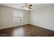 This bedroom features a ceiling fan and wood-look tile floors at 21533 N Greenway Rd, Maricopa, AZ 85138
