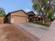 Charming single-story home featuring a two-car garage, neutral stucco, and well-kept landscaping at 21533 N Greenway Rd, Maricopa, AZ 85138