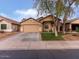 Charming single-story home with a well-maintained lawn, two-car garage, and inviting curb appeal at 21533 N Greenway Rd, Maricopa, AZ 85138