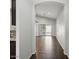 Bright hallway features wood-look tile flooring, neutral paint, and an open archway leading to the living area at 21533 N Greenway Rd, Maricopa, AZ 85138
