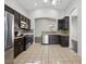 Modern kitchen with stainless steel appliances, granite countertops, tile backsplash, and dark wood cabinets at 21533 N Greenway Rd, Maricopa, AZ 85138