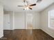 The living room offers wood-look tile floors, a ceiling fan, and neutral decor at 21533 N Greenway Rd, Maricopa, AZ 85138