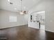 Bright living room featuring wood-look tile flooring and a ceiling fan at 21533 N Greenway Rd, Maricopa, AZ 85138