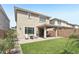A landscaped backyard featuring artificial turf, a patio with cover, and manicured landscape at 22023 N 28Th Pl, Phoenix, AZ 85050