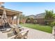 Landscaped backyard featuring a covered patio, brick pavers, lush lawn, and privacy fence at 22023 N 28Th Pl, Phoenix, AZ 85050