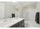 Bathroom featuring a dual vanity with modern fixtures, tub and shower combination and a gray accent towel at 22023 N 28Th Pl, Phoenix, AZ 85050