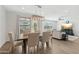 Open dining area with modern lighting, and views into the comfortable living area at 22023 N 28Th Pl, Phoenix, AZ 85050