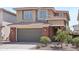 Two-story home featuring an attached garage, brick accents, desert landscaping and neutral paint scheme at 22023 N 28Th Pl, Phoenix, AZ 85050