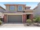 Charming two-story home with a gray garage door, brick pillars, and manicured front yard at 22023 N 28Th Pl, Phoenix, AZ 85050